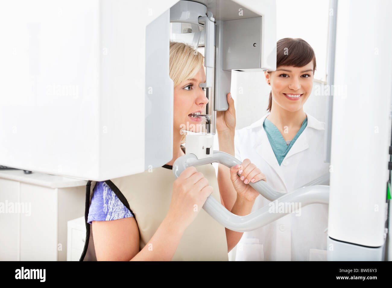 A young dentist taking a panoramic digital X-ray of a patient`s teeth Stock Photo